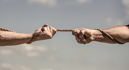 conflict tug of war. hand holding a rope, climbing rope, strength and determination. rescue, help, h