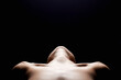 © eugenepartyzan - shoulders of a naked woman. Nude silhouette under light in the dark