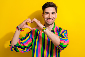 Poster - Photo of young gay boyfriend in retro striped shirt gesturing love to his fans supporting lgbt community isolated on yellow color background