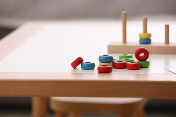 Poster - Stacking and counting game on table indoors, space for text. Educational toy for motor skills development