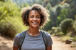 Smiling African American woman enjoying an outdoor hiking adventure showcasing happiness vitality and an active adult lifestyle