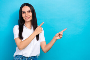 Sticker - Photo of pretty thoughtful lady wear white shirt pointing two fingers looking empty space isolated blue color background