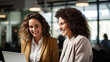 © Studio Nova - Two female coworkers discuss company business matters near a laptop in the office