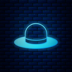 Poster - Glowing neon Man hat with ribbon icon isolated on brick wall background. Vector