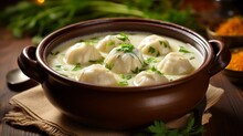 An Image Of A Bowl Of Creamy Chicken And Dumpling Soup With Tender Dumplings