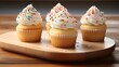 Classic vanilla cupcakes with a swirl of velvety vanilla frosting, topped with sprinkles