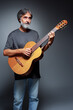 © luengo_ua - Aged bearded man with an acoustic guitar