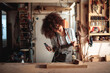 Craftswoman Grooving to Music in a Woodworking Workshop