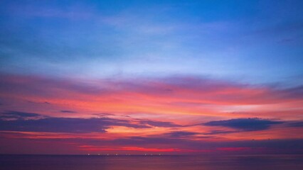 Wall Mural - .Aerial hyperlapse sweet sky cloud scape in colorful sunset..colorful light through to the cloud above the ocean..Nature video High quality footage .Scene of Colorful romantic sky sunset background.