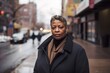 portrait of middle aged serious african american woman standing on the street in the city