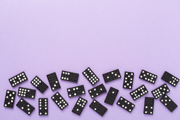 Wall Mural - Black domino tiles on color background, top view