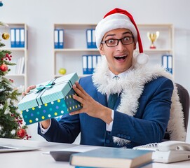 Wall Mural - Businessman celebrating christmas holiday in the office