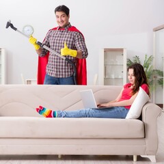 Wall Mural - Superhero husband helping his wife at home