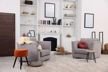 Wall Mural - Comfortable armchairs, fireplace and shelves in living room. Interior design