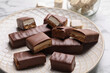 Tasty chocolate bars with nougat on table, closeup