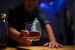 © aekachai - Barman pouring whiskey whiskey glass..