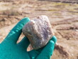 A piece of vein quartz of a bluish tint in the hand