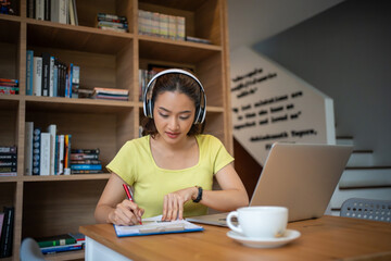 Wall Mural - Young woman having video call via computer in the home office.Business video conferencing.