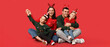 canvas print picture - Happy family in Christmas sweaters on red background