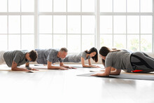 Group Of Sporty People Doing Plank In Gym