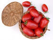 Tomatoes in a basket on a white background. View from above.