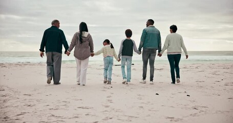 Wall Mural - Big family, holding hands and beach walking happy on cloudy day for connection, grandparents or children love. Mother, father and relax holiday time or bonding at ocean, sea waves for support care