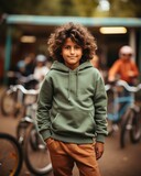 Fototapeta  - Indian kid boy wearing mint colour hoodies on bicycles