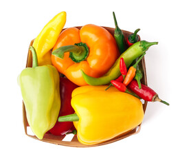 Wall Mural - Chili and bell peppers in basket on white background.