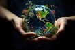 © dashtik - Earth crystal glass globe ball and tree in hands.