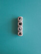 FMLA family medical leave act symbol. Concept words FMLA family medical leave act on wooden cubes. Beautiful blue background.