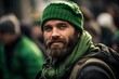 © Irene - A portrait of an attractive man with a green hat and scarf, celebrating St. Patrick's Day in the street parade