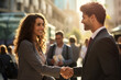 © Surachetsh - A precious scene of a smiling blonde woman in a suit shaking hands with another businessman in a bustling city square with warm sunlight. Generative AI.