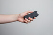 Taser in human's hand close-up on a gray background