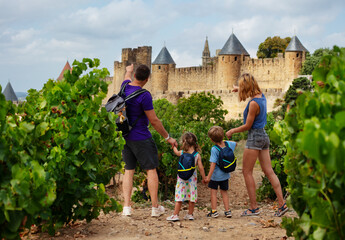 Wall Mural - Family with kids admiring Carcassonne cityscape at summer day