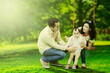 © Creativa Images - Portrait of a joyful family laughing together while playing on a swing at the park