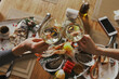 Two young woman clinking glasses with wine over served table with food in cafe or restaurant. Close-up hands with wineglasses