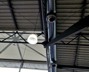 air conditioning vent pipe with tilting pipe diffuser. the ceiling of an industrial building with me