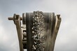 © Wirestock - A photograph of the heavy machinery at the quarry, rocks and sand conveyor belt.