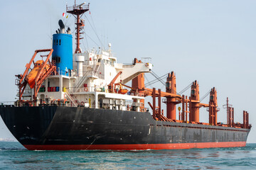 cargo ship in the ocean for export import goods from cargo yard port to customs ocean concept freight shipping by ship