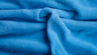 blue soft terrycloth material with folds in background orientation
