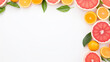 Frame made of fresh orange fruit and grapefruit with leaves on white background. Food concept