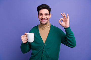 Poster - Photo of cheerful nice man wear stylish clothes arm demonstrate okey sign tasty delicious espresso isolated on purple color background