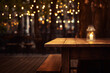 Wooden cafe restaurant empty table with candle outdoor terrace on blurred evening bokeh lights background. Cozy dinner concept