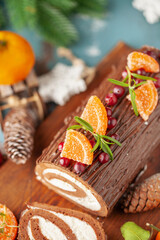 Wall Mural - Yule log roll cake with chocolate ganache  on Christmas decorated background