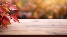 Empty Wooden Table Top, Bathed In Warm Autumnal Hues, With A Beautifully Blurred Background Showcasing The Exuberant Colors Of The Season