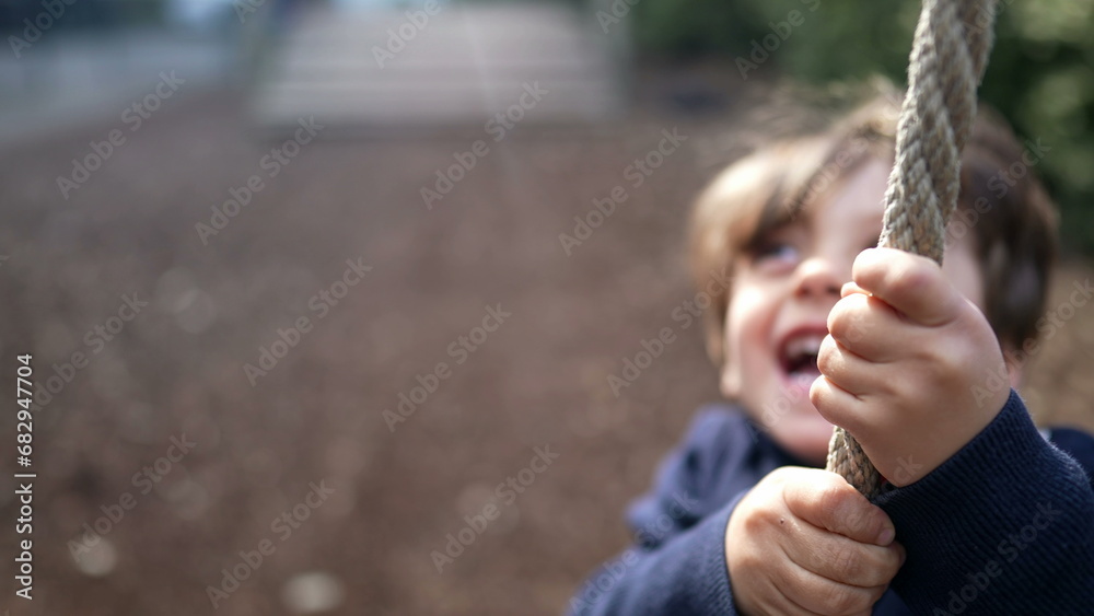 Happy Child Sliding Down Rope at Autumn Playground. Joyful Kid Holding ...