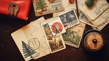 A Collection Of Vintage Christmas Postcards And Stamps Spread Out On A Wooden Table, Merry Christmas Background, Top View, With Copy Space