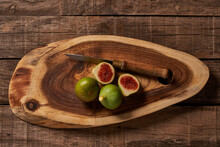 Fresh Figs On Wooden Cutting Board With Knife