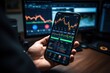 © sirisakboakaew - Crypto trader investor broker holding finger using cell phone app executing financial stock trade market trading