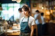 © sirisakboakaew - Young Asian woman coffee shop employee barista working at cafe.